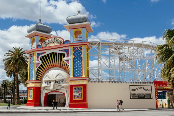 a group of people standing in front of Luna Park, Melbourne